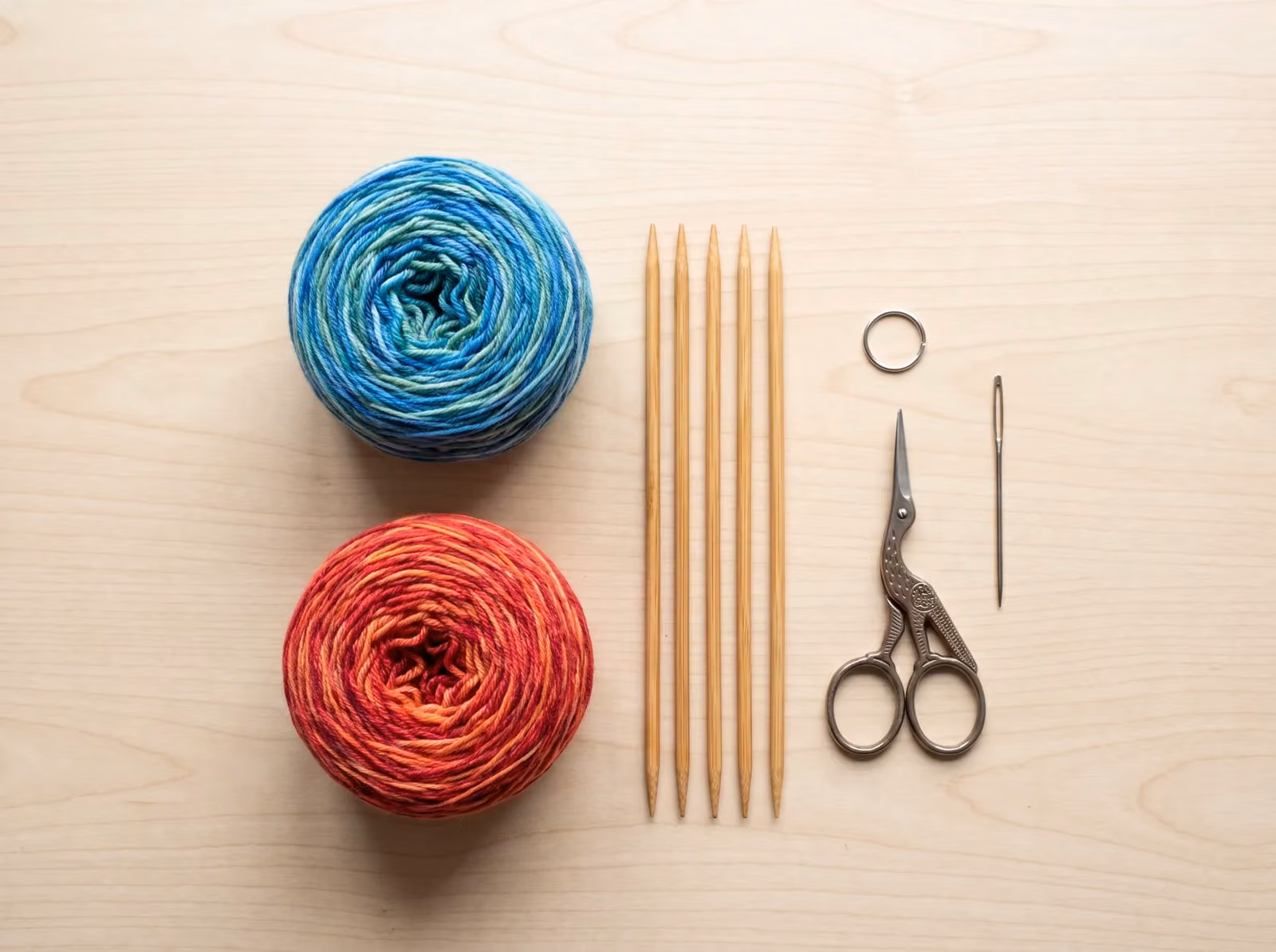 Sockenstrick-Material: Sockenwolle, Nadelspiel, Schere und Wollnadel